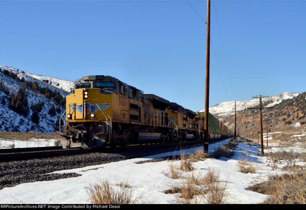 UP 8664, 9021, 7781 (SD70ACE, SD70ACE, C45ACCTE) lead an eastbound stack train through Echo Canyon Utah (near Baskin) February 19, 2022 {Winter Echofest}